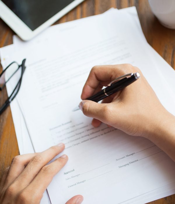 Unrecognizable man filling application form. Businessman checking papers. He signing document. Manager working with report. Financial report concept